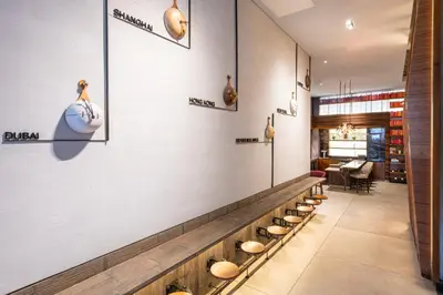 a row of bowls on the wall of a restaurant at Hyatt Herald Square New York in New York