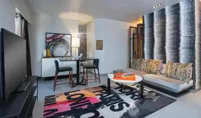a living room with a couch and a table at Hyatt Herald Square New York in New York