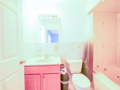 a pink bathroom with a sink and a toilet at Cozy 3 - Bed apartment, Minutes from NYC! in Jersey City