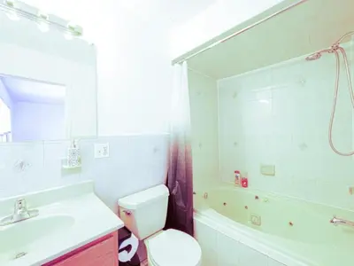 a bathroom with a sink and a toilet and a tub at Cozy 3 - Bed apartment, Minutes from NYC! in Jersey City