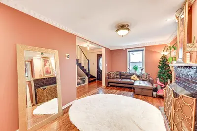 a living room with a couch and a fireplace at Welcoming Glen Cove Home about 1 Mi to Public Beach! in Glen Cove