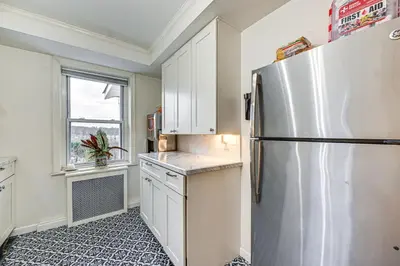 a kitchen with a stainless steel refrigerator and a window at Welcoming Glen Cove Home about 1 Mi to Public Beach! in Glen Cove