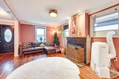 a living room with a couch and a fireplace at Welcoming Glen Cove Home about 1 Mi to Public Beach! in Glen Cove