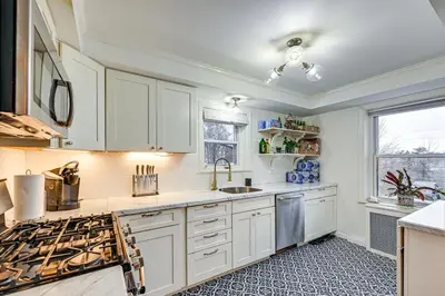 a kitchen with white cabinets and a sink at Welcoming Glen Cove Home about 1 Mi to Public Beach! in Glen Cove