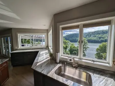 a kitchen with a sink and a large window at Candlewood Lake -Family Getaway, Lakefront 3775 sqft Home in Danbury