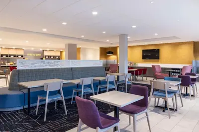 a restaurant with tables and chairs and a bar at Home2 Suites By Hilton East Haven New Haven in East Haven