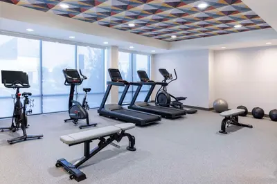 a gym with several treadmills and exercise bikes at Home2 Suites By Hilton East Haven New Haven in East Haven