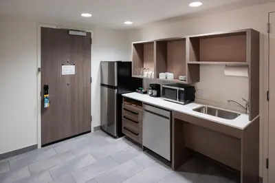 a small kitchen with a sink and a refrigerator at Home2 Suites By Hilton East Haven New Haven in East Haven