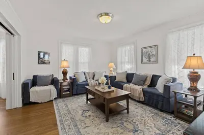 a living room with blue couches and a coffee table at Prime West Hartford Center Location- Historic Gem in West Hartford