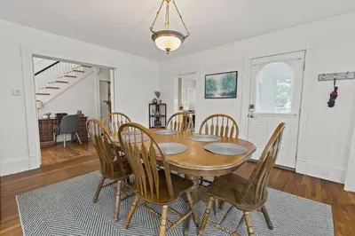 a dining room with a wooden table and chairs at Prime West Hartford Center Location- Historic Gem in West Hartford