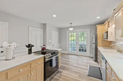 a kitchen with a stove top oven in a room at Prime West Hartford Center Location- Historic Gem in West Hartford