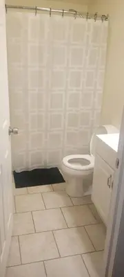 a white bathroom with a toilet and a sink at The place to relax in Schenectady
