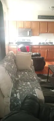 a living room with a couch and a kitchen at The place to relax in Schenectady