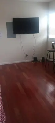 a room with a flat screen tv on a wall at the rest spot in Schenectady