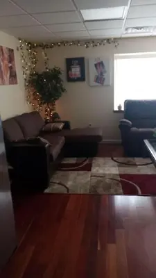 a living room with a couch and a rug at Suite 3 in Schenectady
