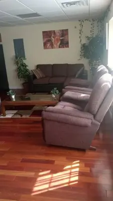 a living room with a couch and a coffee table at Suite 3 in Schenectady