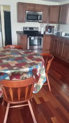 a kitchen with a table and a stove top oven at Suite 3 in Schenectady
