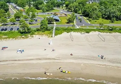 an aerial view of a beach with people on the sand at Bobby's Beach Bungalow in Milford