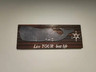 a picture of a whale on a wooden box at Bobby's Beach Bungalow in Milford