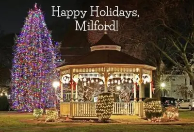 a christmas tree in front of a gazebo with a christmas at Bobby's Beach Bungalow in Milford