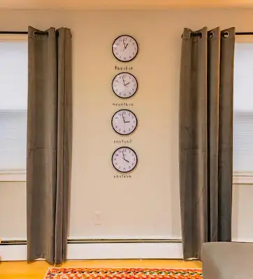 four clocks on a wall on a wall at New Beautiful Apartment In Bayonne near Subway Path Train Manhattan NYC in Bayonne
