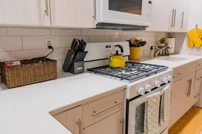 a kitchen with a stove top oven in a kitchen at New Beautiful Apartment In Bayonne near Subway Path Train Manhattan NYC in Bayonne
