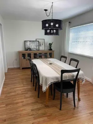 a dining room with a table with chairs and a chandelier at 2023 Remodeled 4bed/2bath Home! in Gansevoort