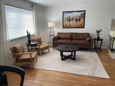 a living room with a couch and a table and chairs at 2023 Remodeled 4bed/2bath Home! in Gansevoort
