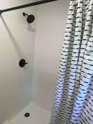 a bathroom with a shower with a shower curtain at 2023 Remodeled 4bed/2bath Home! in Gansevoort