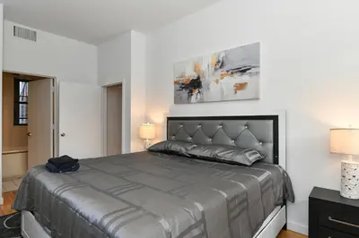 a bedroom with a large bed and two lamps at Luxury 3 Bedroom Retreat in Downtown Manhattan in New York