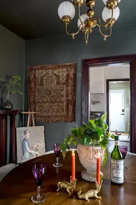 a dining room with a table with candles and a painting at Designer Home, Hot Tub, Private Yard, & Projector in Hudson