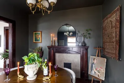 a dining room with a table and a fireplace at Designer Home, Hot Tub, Private Yard, & Projector in Hudson