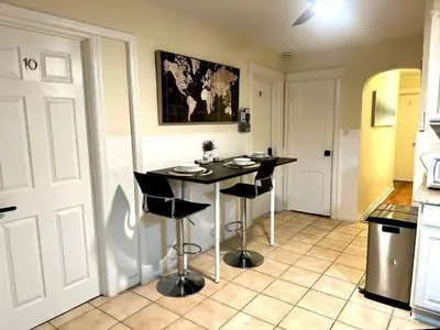 a kitchen with a table and chairs in a room at 7-A Diamond in Yonkers in Yonkers