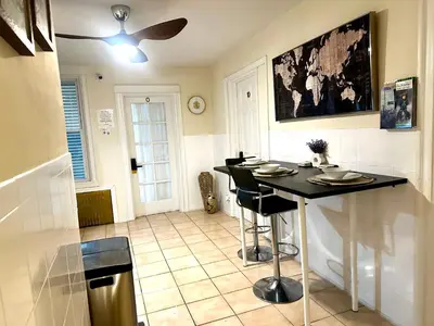 a kitchen with a table and a ceiling fan at 7-A Diamond in Yonkers in Yonkers