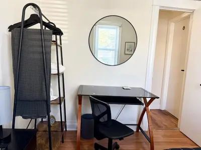 a desk in a room with a mirror and a chair at 7-A Diamond in Yonkers in Yonkers