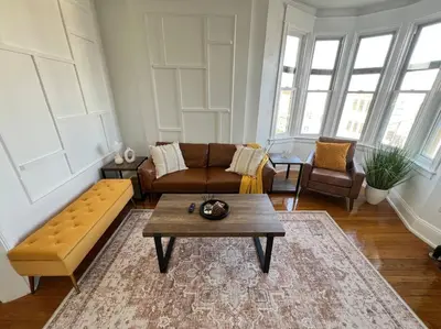 a living room with a couch and a coffee table at 1BR Apt 5mins to Proctors in Schenectady