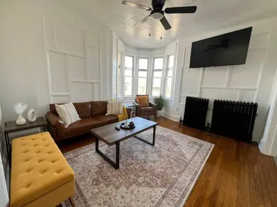 a living room with a couch and a table at 1BR Apt 5mins to Proctors in Schenectady