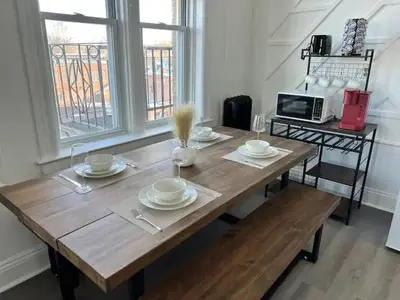a wooden table with plates and dishes on it at 1BR Apt 5mins to Proctors in Schenectady