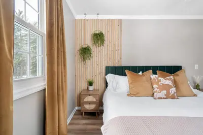 a bedroom with a bed with pillows and a window at Game Room+Hot Tub+Pool+King Beds+More in Gansevoort