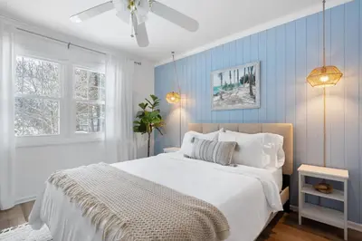 a bedroom with a white bed and blue walls at Game Room+Hot Tub+Pool+King Beds+More in Gansevoort
