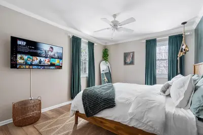 a bedroom with a bed and a flat screen tv at Game Room+Hot Tub+Pool+King Beds+More in Gansevoort