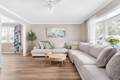 a living room with a couch and a table at Game Room+Hot Tub+Pool+King Beds+More in Gansevoort