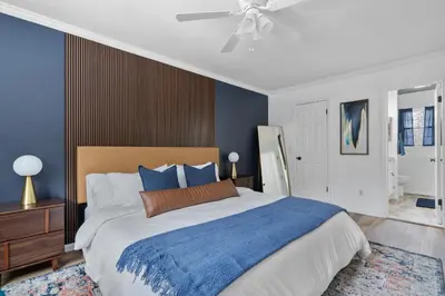 a bedroom with a large bed and a ceiling fan at Game Room+Hot Tub+Pool+King Beds+More in Gansevoort