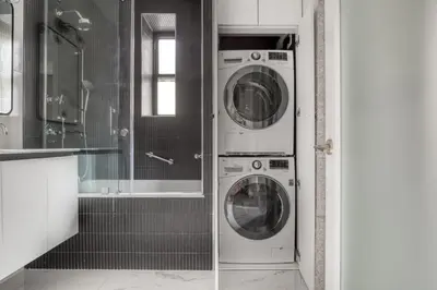 two washer and dryer machines in a bathroom at Brooklyn Heights 2br w elevator wd NYC-1066 in Brooklyn