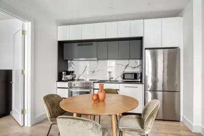 a kitchen with a wooden table and chairs at Brooklyn Heights 2br w elevator wd NYC-1066 in Brooklyn