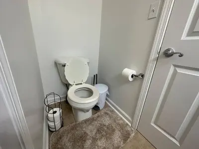 a small bathroom with a toilet and a door at Great Value Close to Proctors Gorgeous Townhouse in Schenectady
