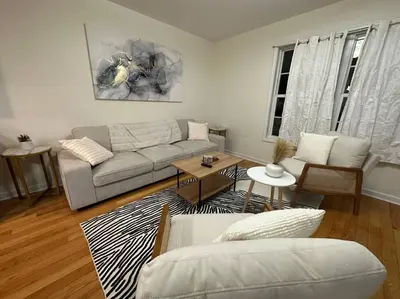 a living room with a couch and a table at Great Value Close to Proctors Gorgeous Townhouse in Schenectady