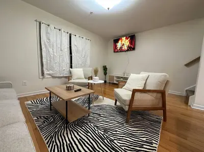 a living room with a couch and a table at Great Value Close to Proctors Gorgeous Townhouse in Schenectady
