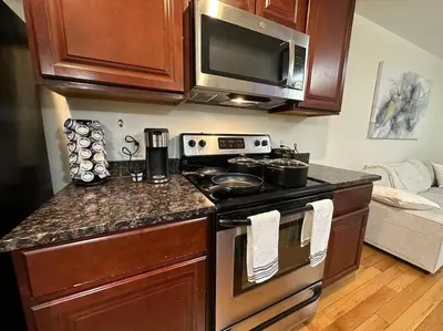 a kitchen with a stove and a microwave at Great Value Close to Proctors Gorgeous Townhouse in Schenectady