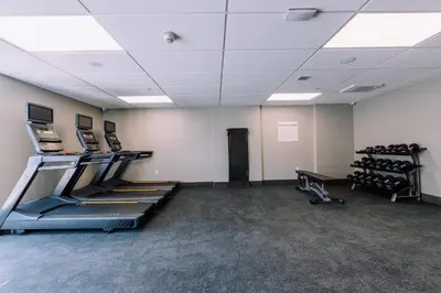 a gym with treadmills and machines in a room at Holiday Inn Express Long Island City E - New York by IHG in Queens